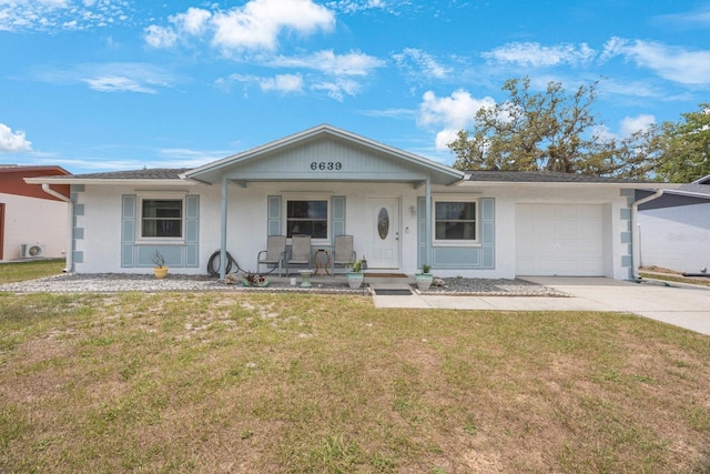 6639 Winding Oak Dr, Tampa, FL 33625 - ranch-style house with a porch, driveway, an attached garage, a front lawn, and stucco siding