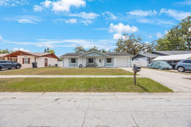 6639 Winding Oak Dr, Tampa, FL 33625 - ranch-style house with a garage, driveway, a front yard, and a porch