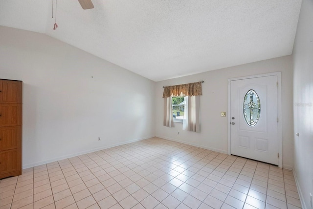 6639 Winding Oak Dr, Tampa, FL 33625 - foyer with vaulted ceiling, ceiling fan, light tile patterned floors, a textured ceiling, and baseboards