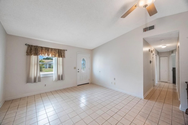 6639 Winding Oak Dr, Tampa, FL 33625 - entrance foyer with lofted ceiling, ceiling fan, light tile patterned flooring, baseboards, and a textured ceiling