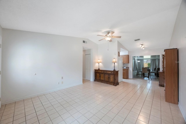 6639 Winding Oak Dr, Tampa, FL 33625 - living room featuring vaulted ceiling, ceiling fan, light tile patterned floors, and baseboards