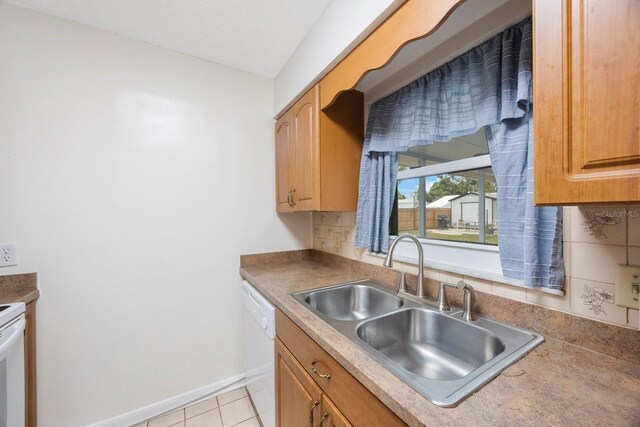 6639 Winding Oak Dr, Tampa, FL 33625 - kitchen with a sink, white dishwasher, baseboards, and light tile patterned flooring
