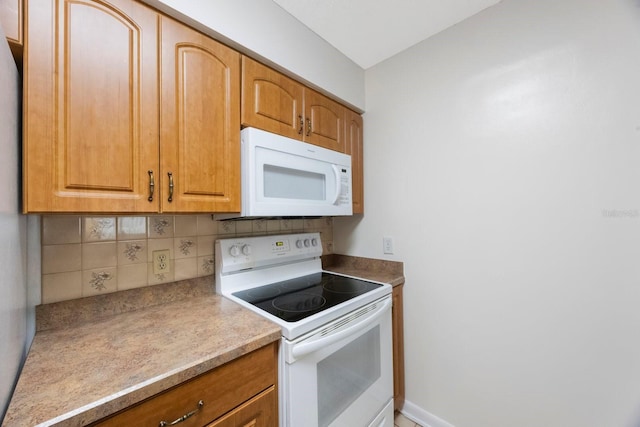 6639 Winding Oak Dr, Tampa, FL 33625 - kitchen with white appliances, tasteful backsplash, brown cabinetry, and light countertops