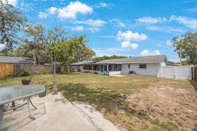 6639 Winding Oak Dr, Tampa, FL 33625 - rear view of property with a sunroom, a gate, a patio, and central AC unit
