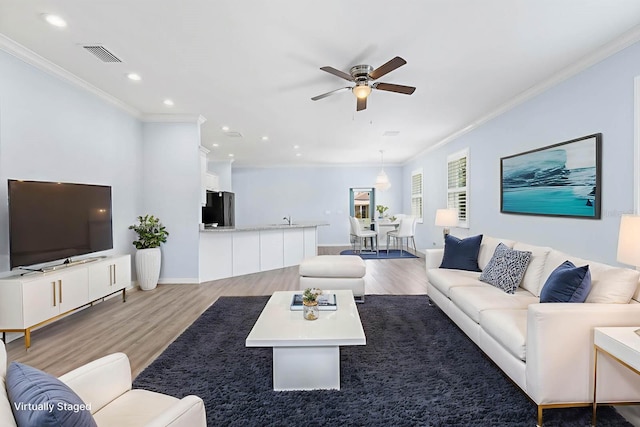 11016 Kiskadee Cir, New Port Richey, FL 34654 - living room featuring crown molding, light wood-type flooring, a ceiling fan, recessed lighting, and baseboards