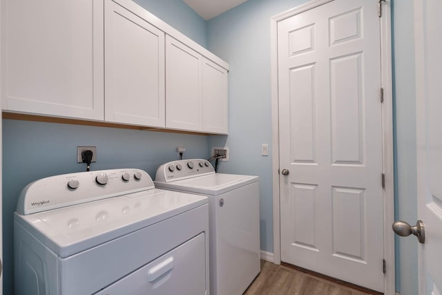 11016 Kiskadee Cir, New Port Richey, FL 34654 - laundry area featuring cabinet space, washing machine and dryer, light wood-type flooring, and baseboards