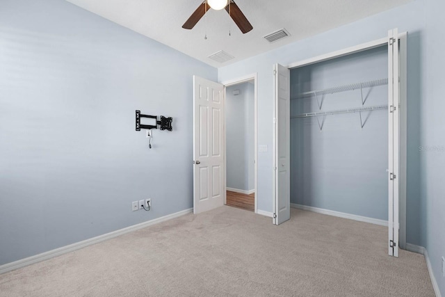 11016 Kiskadee Cir, New Port Richey, FL 34654 - unfurnished bedroom featuring carpet floors, a closet, a ceiling fan, and baseboards
