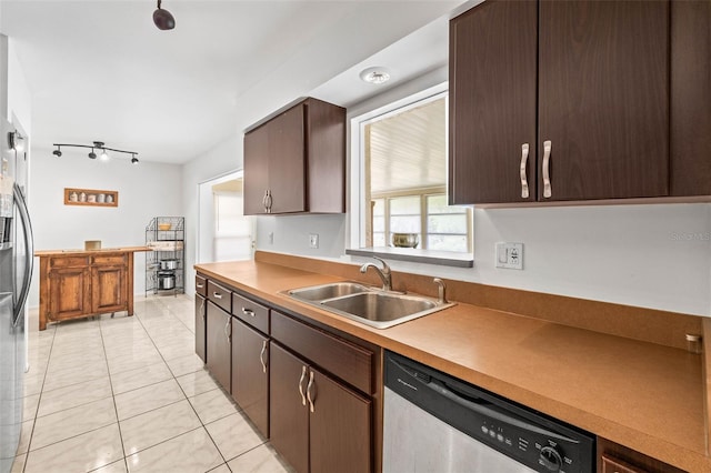 1410 Brighton Ct, Palm Harbor, FL 34684 - kitchen with appliances with stainless steel finishes, a sink, light tile patterned flooring, dark brown cabinets, and light countertops