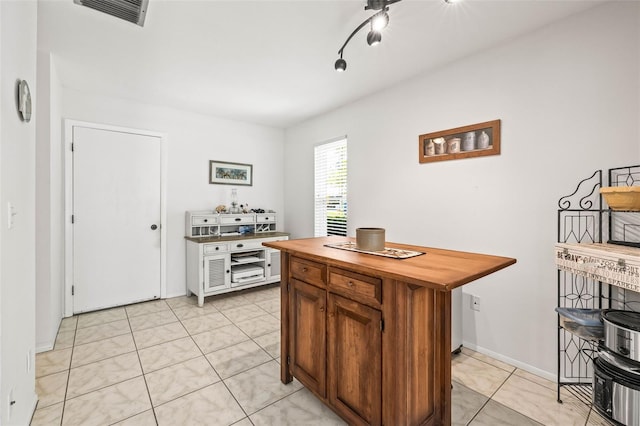 1410 Brighton Ct, Palm Harbor, FL 34684 - kitchen with wooden counters, brown cabinets, and light tile patterned flooring