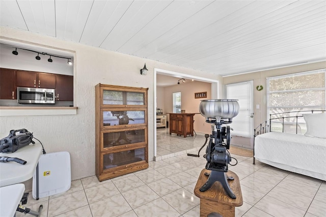 1410 Brighton Ct, Palm Harbor, FL 34684 - living room featuring track lighting, wood ceiling, and light tile patterned floors