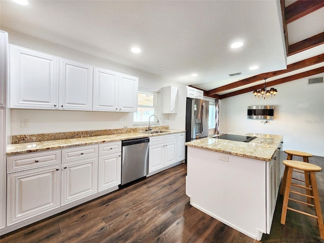 4102 Stonehenge Rd, Mulberry, FL 33860 - kitchen featuring stainless steel appliances, a sink, dark wood-type flooring, a kitchen island, and white cabinets