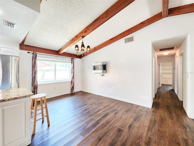 4102 Stonehenge Rd, Mulberry, FL 33860 - unfurnished living room featuring dark wood-style floors, a textured ceiling, a chandelier, and baseboards