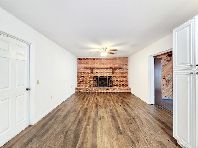 4102 Stonehenge Rd, Mulberry, FL 33860 - unfurnished living room featuring ceiling fan, wood finished floors, and a fireplace