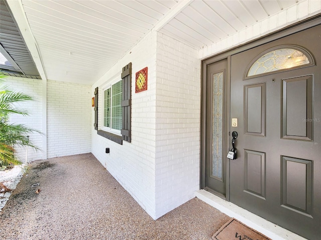 4102 Stonehenge Rd, Mulberry, FL 33860 - doorway to property featuring brick siding and a porch