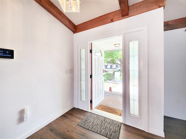 4102 Stonehenge Rd, Mulberry, FL 33860 - entrance foyer with beam ceiling, dark wood-style flooring, baseboards, and a textured ceiling