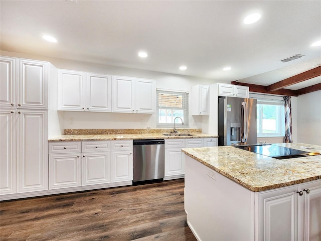 4102 Stonehenge Rd, Mulberry, FL 33860 - kitchen with appliances with stainless steel finishes, a sink, dark wood-type flooring, white cabinets, and recessed lighting