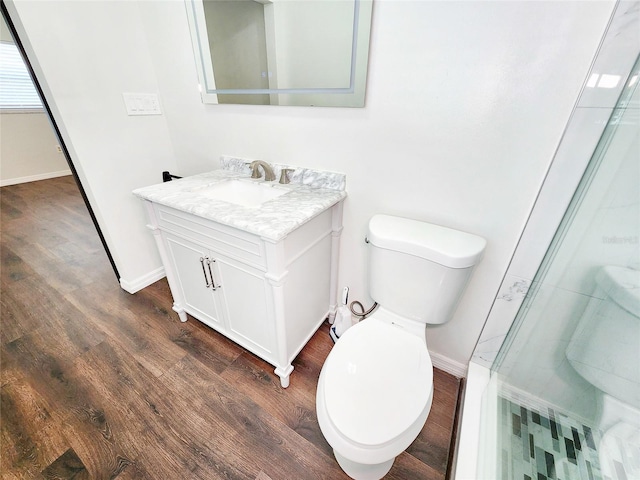 4102 Stonehenge Rd, Mulberry, FL 33860 - bathroom featuring toilet, vanity, wood finished floors, and baseboards