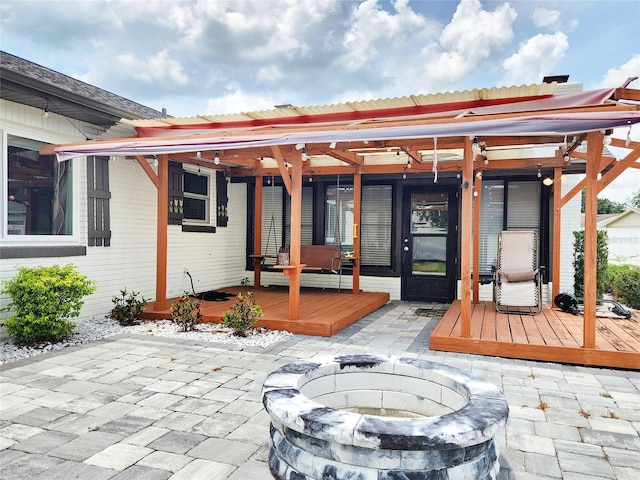 4102 Stonehenge Rd, Mulberry, FL 33860 - rear view of property featuring a fire pit, a patio area, and a wooden deck