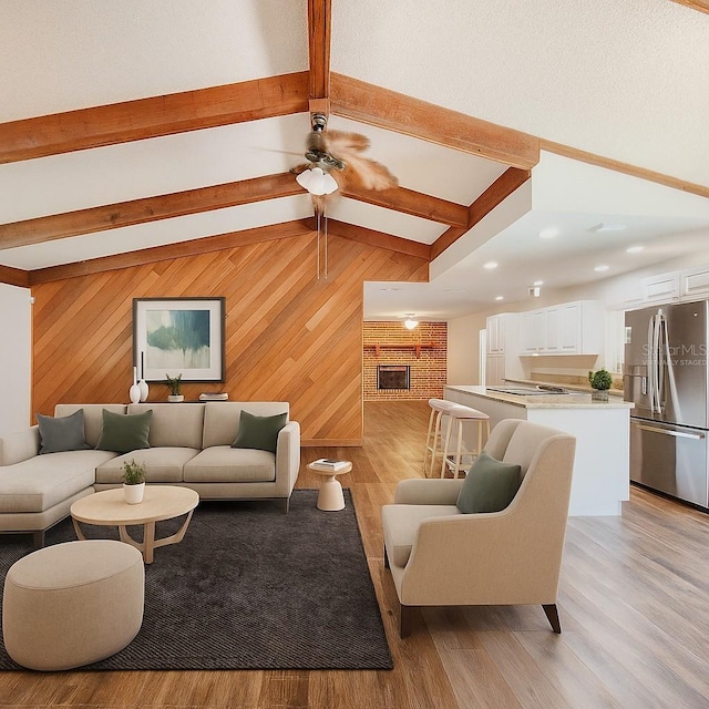 4102 Stonehenge Rd, Mulberry, FL 33860 - living room featuring wood walls, light wood-style floors, a brick fireplace, and ceiling fan