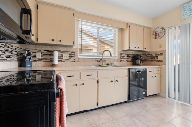 4036 Davit Dr, New Port Richey, FL 34652 - kitchen with black appliances, a sink, light countertops, cream cabinetry, and backsplash