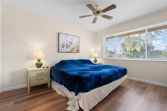 4036 Davit Dr, New Port Richey, FL 34652 - bedroom featuring baseboards, wood finished floors, and a ceiling fan