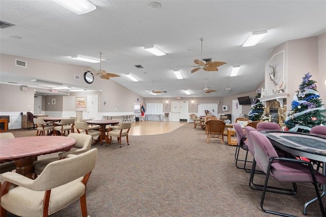 4036 Davit Dr, New Port Richey, FL 34652 - dining room featuring lofted ceiling, a fireplace, carpet, and ceiling fan