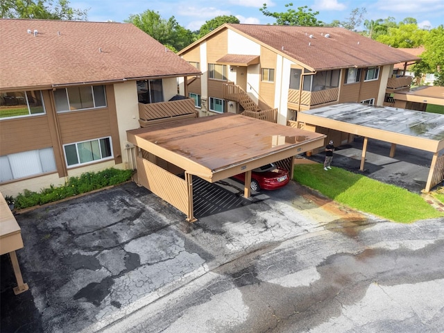 4036 Davit Dr, New Port Richey, FL 34652 - back of property with covered parking, stucco siding, and a shingled roof