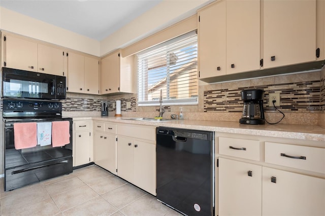 4036 Davit Dr, New Port Richey, FL 34652 - kitchen featuring black appliances, a sink, light countertops, cream cabinetry, and light tile patterned floors
