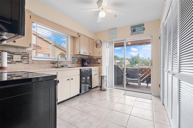 4036 Davit Dr, New Port Richey, FL 34652 - kitchen featuring light countertops, a ceiling fan, tasteful backsplash, black dishwasher, and light tile patterned flooring