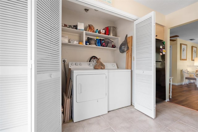 4036 Davit Dr, New Port Richey, FL 34652 - laundry room with washing machine and clothes dryer and light tile patterned flooring