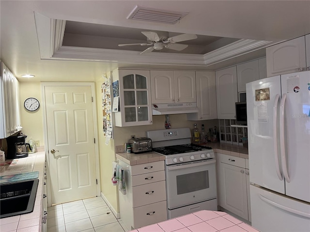405 Bryn Mawr Is, Bradenton, FL 34207 - kitchen featuring white appliances, tile counters, a tray ceiling, and crown molding
