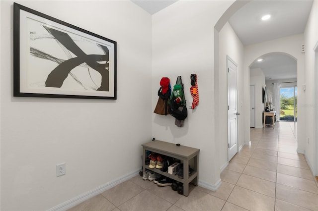 34248 Redwood Dawn Ln, Wesley Chapel, FL 33543 - hall with arched walkways, light tile patterned floors, baseboards, and recessed lighting