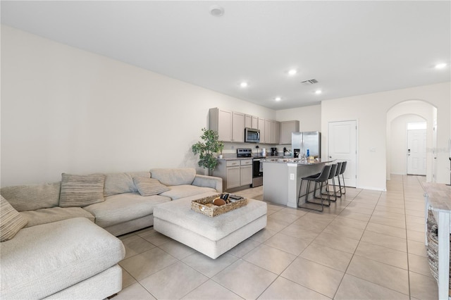 34248 Redwood Dawn Ln, Wesley Chapel, FL 33543 - living area featuring arched walkways, light tile patterned flooring, and recessed lighting