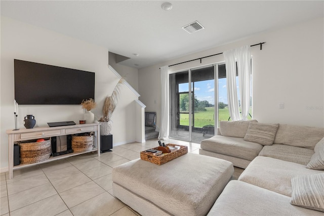 34248 Redwood Dawn Ln, Wesley Chapel, FL 33543 - living room with light tile patterned flooring, baseboards, and a fireplace