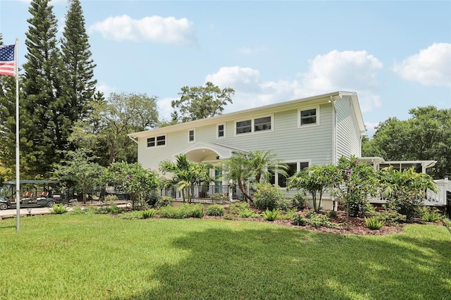1709 Main St, Safety Harbor, FL 34695 - rear view of property featuring a yard