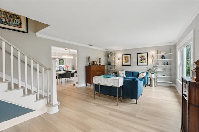 1709 Main St, Safety Harbor, FL 34695 - living room featuring healthy amount of natural light, light wood-style floors, crown molding, a chandelier, and baseboards