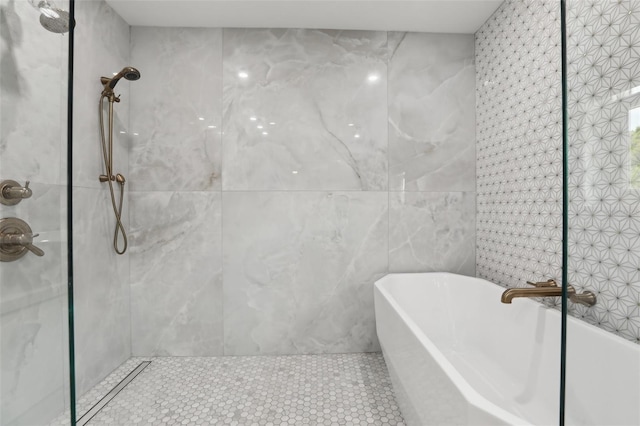 1709 Main St, Safety Harbor, FL 34695 - full bathroom featuring a tile shower, tile walls, a freestanding tub, and tile patterned flooring