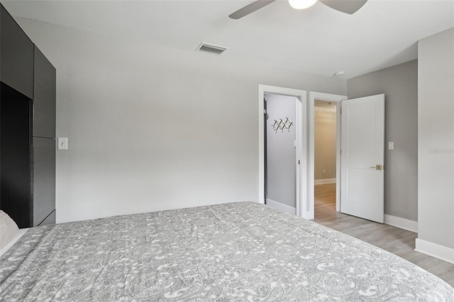 1709 Main St, Safety Harbor, FL 34695 - unfurnished bedroom featuring light wood-style flooring, a ceiling fan, and baseboards