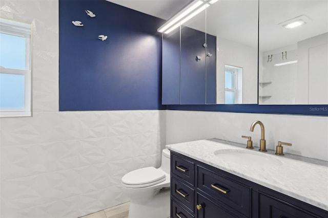 1709 Main St, Safety Harbor, FL 34695 - bathroom featuring vanity, toilet, and tile walls