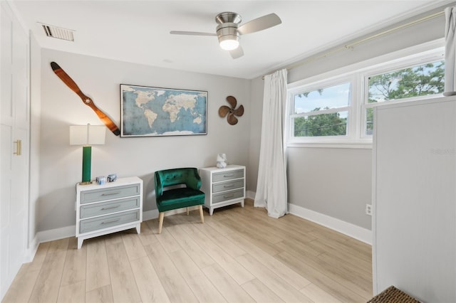 1709 Main St, Safety Harbor, FL 34695 - living area with light wood finished floors, a ceiling fan, and baseboards