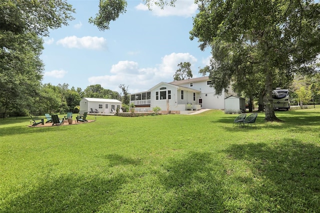 1709 Main St, Safety Harbor, FL 34695 - view of grassy yard with a patio area and a fire pit