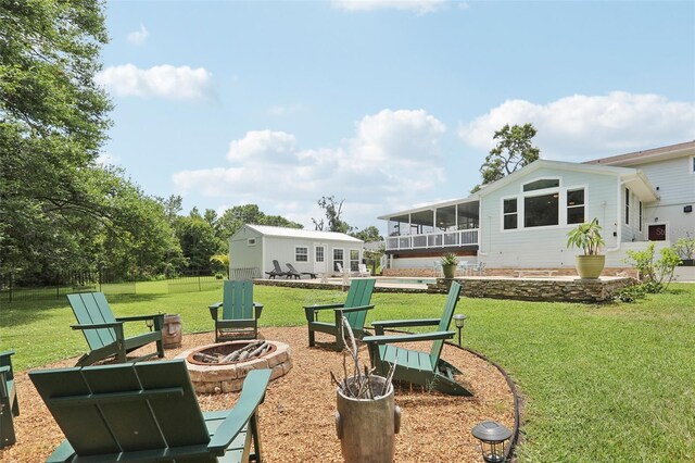 1709 Main St, Safety Harbor, FL 34695 - view of grassy yard featuring an outdoor fire pit, a sunroom, and a patio