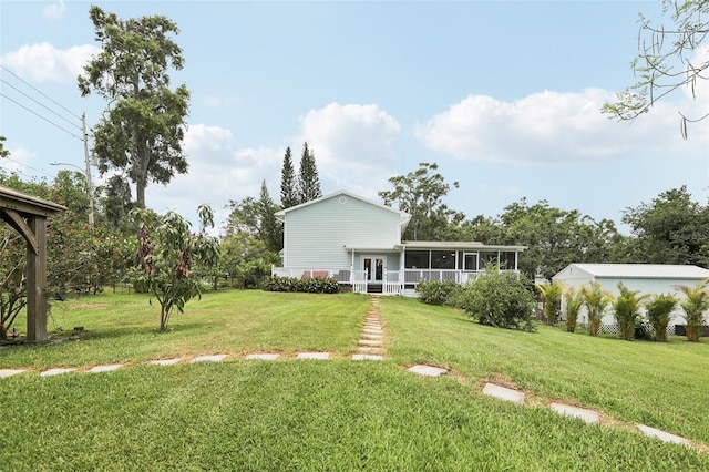 1709 Main St, Safety Harbor, FL 34695 - rear view of property featuring a lawn and a sunroom