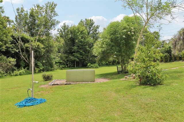 1709 Main St, Safety Harbor, FL 34695 - view of grassy yard with view of scattered trees and central AC unit