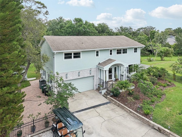 1709 Main St, Safety Harbor, FL 34695 - view of front facade with concrete driveway, an attached garage, a shingled roof, and a porch
