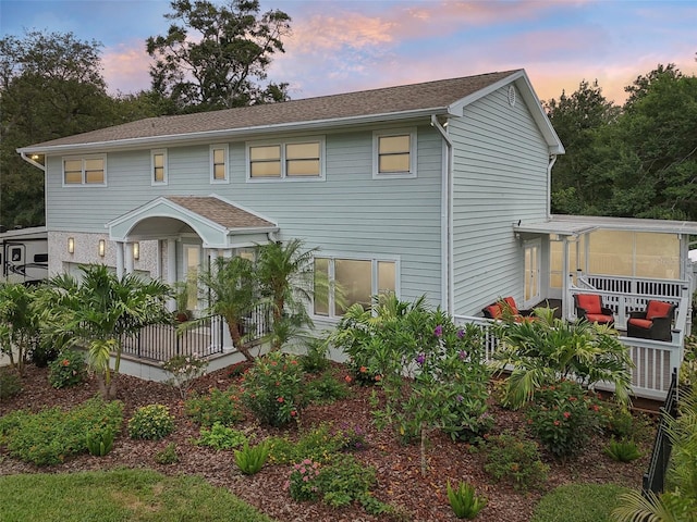 1709 Main St, Safety Harbor, FL 34695 - view of front of property with a shingled roof and a sunroom