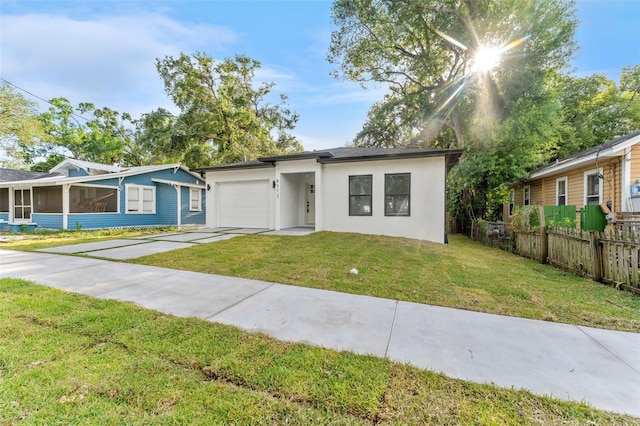 8112 N 10th St, Tampa, FL 33604 - view of front of property with an attached garage, concrete driveway, stucco siding, and a sunroom