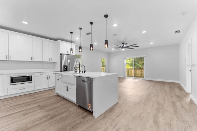 8112 N 10th St, Tampa, FL 33604 - kitchen featuring stainless steel appliances, light countertops, light wood-style floors, ceiling fan, and recessed lighting