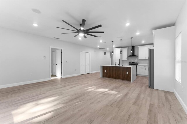 8112 N 10th St, Tampa, FL 33604 - unfurnished living room featuring a ceiling fan, light wood-type flooring, recessed lighting, and baseboards