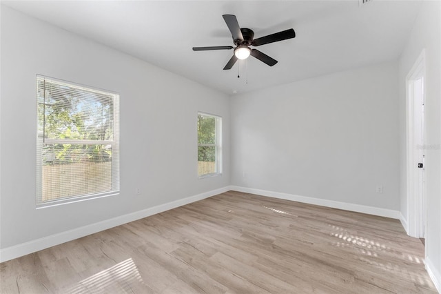 8112 N 10th St, Tampa, FL 33604 - empty room featuring light wood finished floors, baseboards, and a ceiling fan